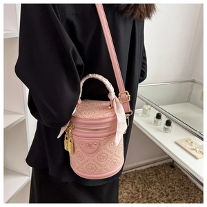 Pink embossed leather cylindrical bucket bag with silk scarf handle and gold hardware