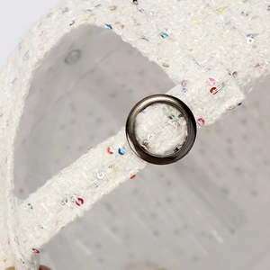 White tweed baseball cap with sequins showing adjustable metal buckle closure detail