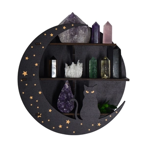 Detailed view of crescent moon wooden shelf with star cutouts and a black cat silhouette
