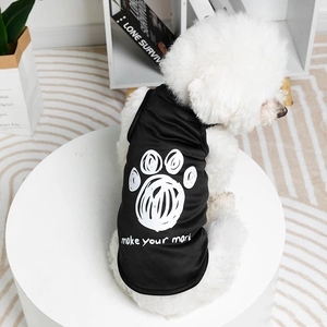 Black pet vest with white paw print and make your mark slogan on a small dog
