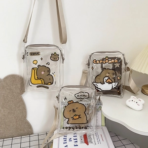 Detail of transparent PVC crossbody bags featuring cute cartoon capybara prints