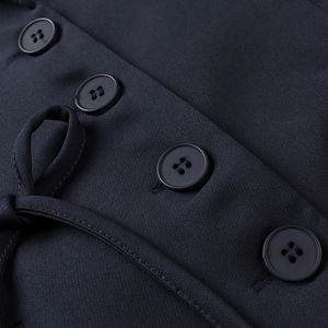 Detail of dark blue blazer featuring four-hole resin buttons and fine twill fabric texture