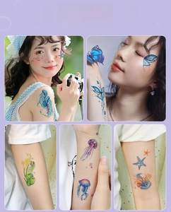 Model display of blue glitter tattoo stickers featuring ocean creatures and butterflies