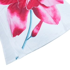 Detailed close-up of pink floral print and double-needle stitching on white dress hem