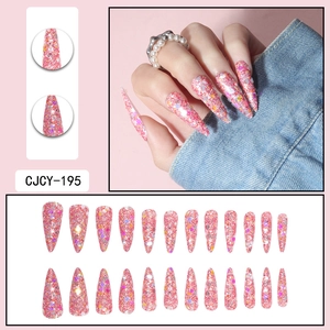 Close-up of pink stiletto press-on nails with colorful sequins and fine glitter set