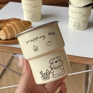 Close-up of cute cartoon dog doodle camping cups made of beige stainless steel