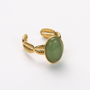Detail of vintage 18k gold plated stainless steel ring with green oval stone
