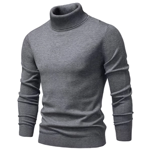 Detailed view of dark grey turtleneck knit sweater with ribbed cuffs and hem textures