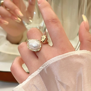 Vintage irregular baroque pearl ring with gold plating shown on model's hand