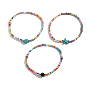 Close-up of bohemian beaded anklets with turquoise and blue starfish charms