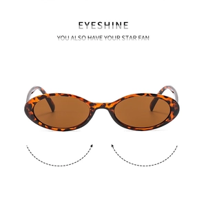 Front view of retro oval sunglasses with amber tortoiseshell frames and brown lenses