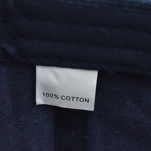 Detail of internal fabric label showing 100% cotton material on the navy blue baseball cap