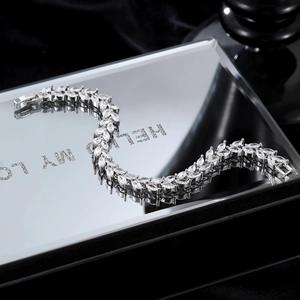 Elegant silver marquise cut zircon tennis bracelet on a black reflective background