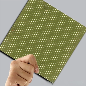 Detail showing olive green paper with white polka dots for vintage scrapbooking crafts