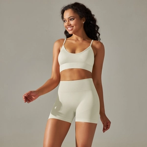 Close-up of seamless ribbed texture on cream high-waisted yoga shorts and sports bra set