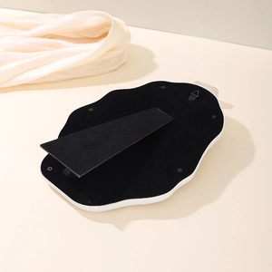 Detail of cloud vanity mirror back with black velvet, adjustable stand and metal wall hook