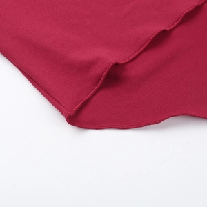 Close-up of red knit fabric with detailed stitching and refined mesh shoulder texture