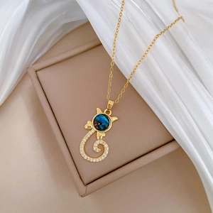 Detail of gold cat pendant necklace with blue celestial stone and zircon accents