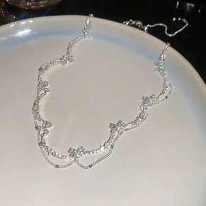 Sparkling butterfly necklace with blue zircon stones on double silver wavy chains