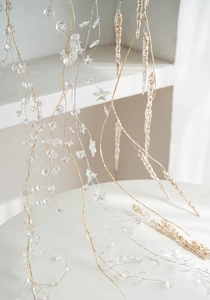 Detail of acrylic clear star and bead garland with gold and silver hanging strings
