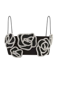 Detail of black crop top featuring five large 3D silver sequin roses on a white background