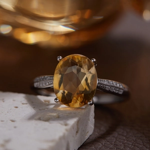 Macro shot of S925 silver ring with oval yellow citrine and pave diamond accents