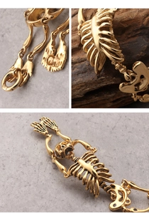 Detailed close-up of gold skull bone links and clasp on a vintage gothic bracelet