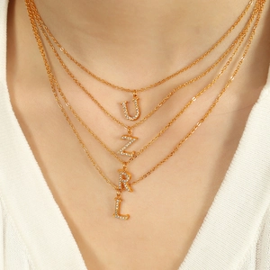 Elegant multi-layered gold titanium steel necklace with sparkling crystal initial pendants