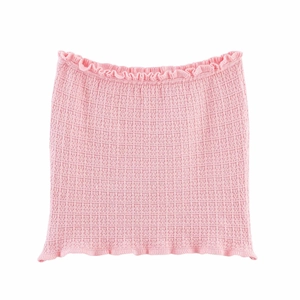 Detailed view of pink knitted tube top with textured fabric and ruffle edges
