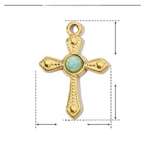 Detail view of a 19mm cross pendant made of stainless steel and natural green stone