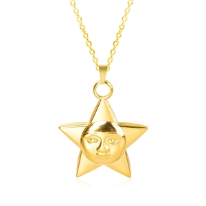 Macro detail of star shaped pendant featuring a face relief and 18k gold plating