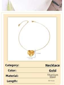Detail of gold titanium steel necklace featuring a large heart pendant and 40+6cm chain