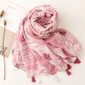 Détail de l'écharpe en coton-lin rose avec imprimé marguerites et pompons à franges