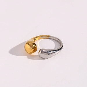 Detailed view of bicolor open ring with teardrop ends in gold and silver finish