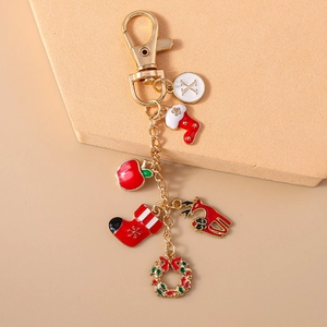 Detailed Christmas keychain with letter X charm, red stocking, and festive wreath pendants