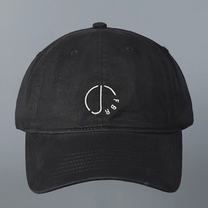 Close-up of white FBR letter embroidery on a premium black washed cotton baseball cap