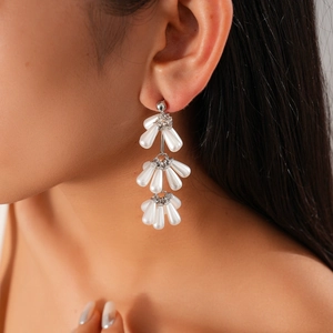 Close-up of elegant white pearl drop tassel earrings on model showing stylish drape