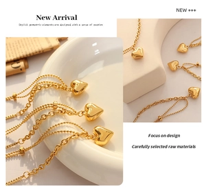 Detailed view of polished 3D gold heart pendant with stylish mixed bead and link chain