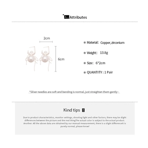 Detailed specs of spider-shaped pearl drop earrings with silver pins and zircon stones