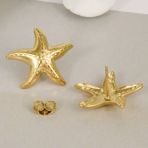 Macro detail of gold starfish stud earrings in 304 stainless steel with butterfly backs