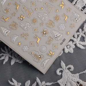 Detailed 5D embossed Christmas nail stickers with gold reindeer and snowflake patterns