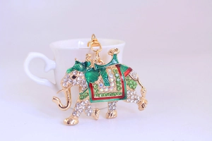 Macro detail of golden elephant keychain featuring colorful enamel and sparkling rhinestones