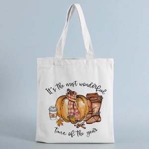 Detail of canvas tote bag featuring watercolor pumpkin illustrations and festive text