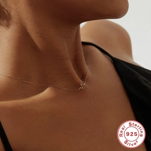 Minimalist S925 sterling silver snake pendant necklace in gold worn by a model