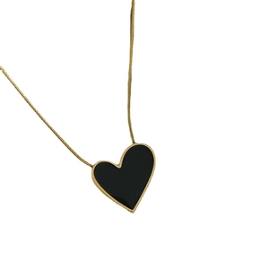 Elegant gold snake chain necklace featuring a black heart pendant with golden metal trim
