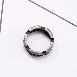 Macro detail of vintage silver stainless steel blade-style ring with serrated edges