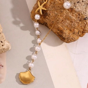 Close-up of 18K gold plated starfish and shell pendant necklace with white pearls