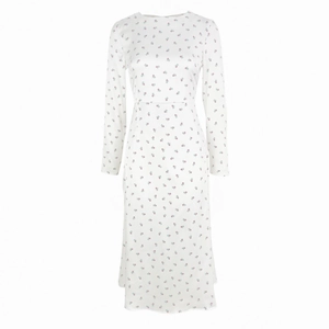 Close-up of a white long-sleeve floral dress with detailed red flower patterns