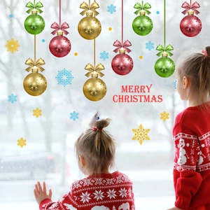 Christmas window decals with colorful baubles and snowflakes in a cozy room setting