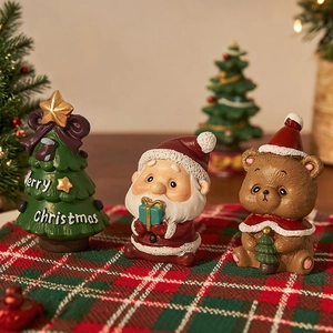 Miniature resin Christmas figurine set with Santa and tree on festive plaid fabric